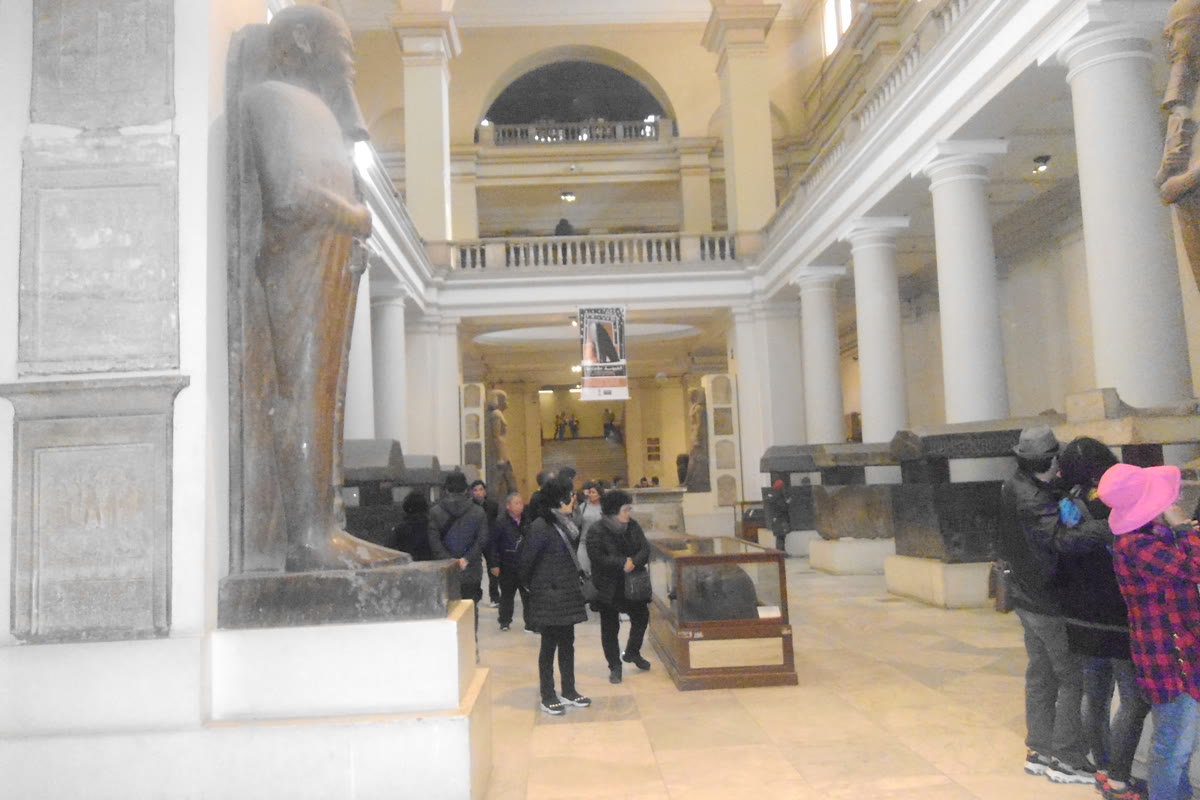 Visitors and display cases in the central hall of the Egyptian Museum in Cairo